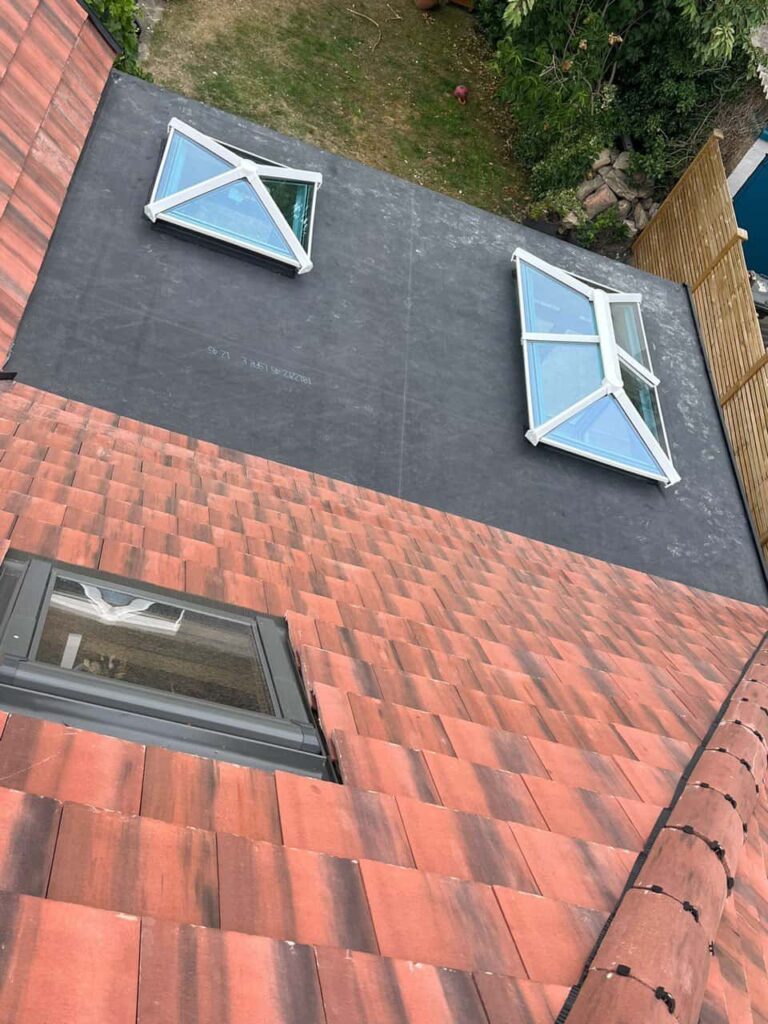 This is a photo taken from the roof ridge looking down a tiled pitched roof on to a flat roof. Works carried out by TRP Roofing Bransholme